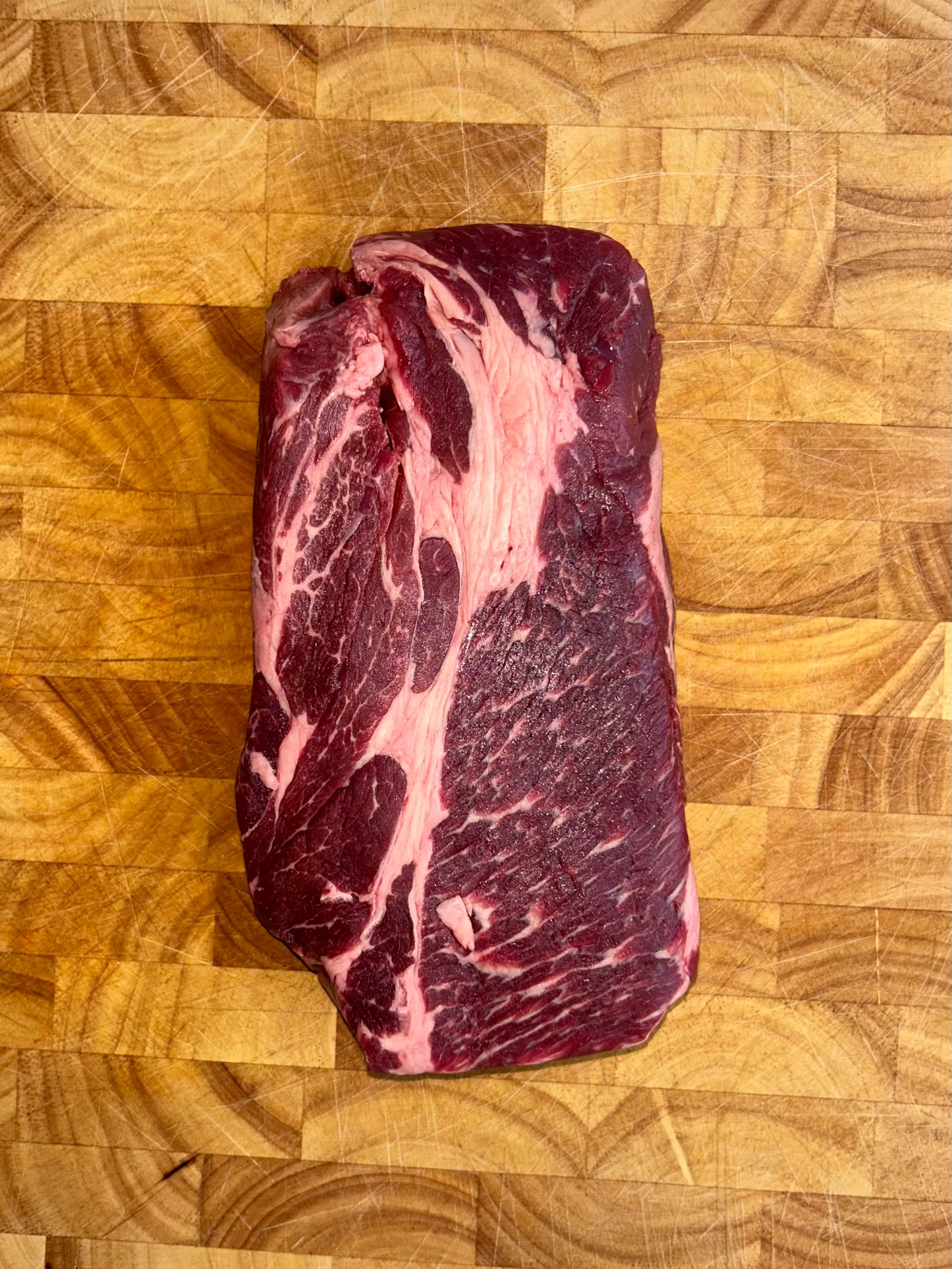 Kosher boneless chuck roast raw vacuum sealed large cut with visible marbling ideal for slow cooking and braising