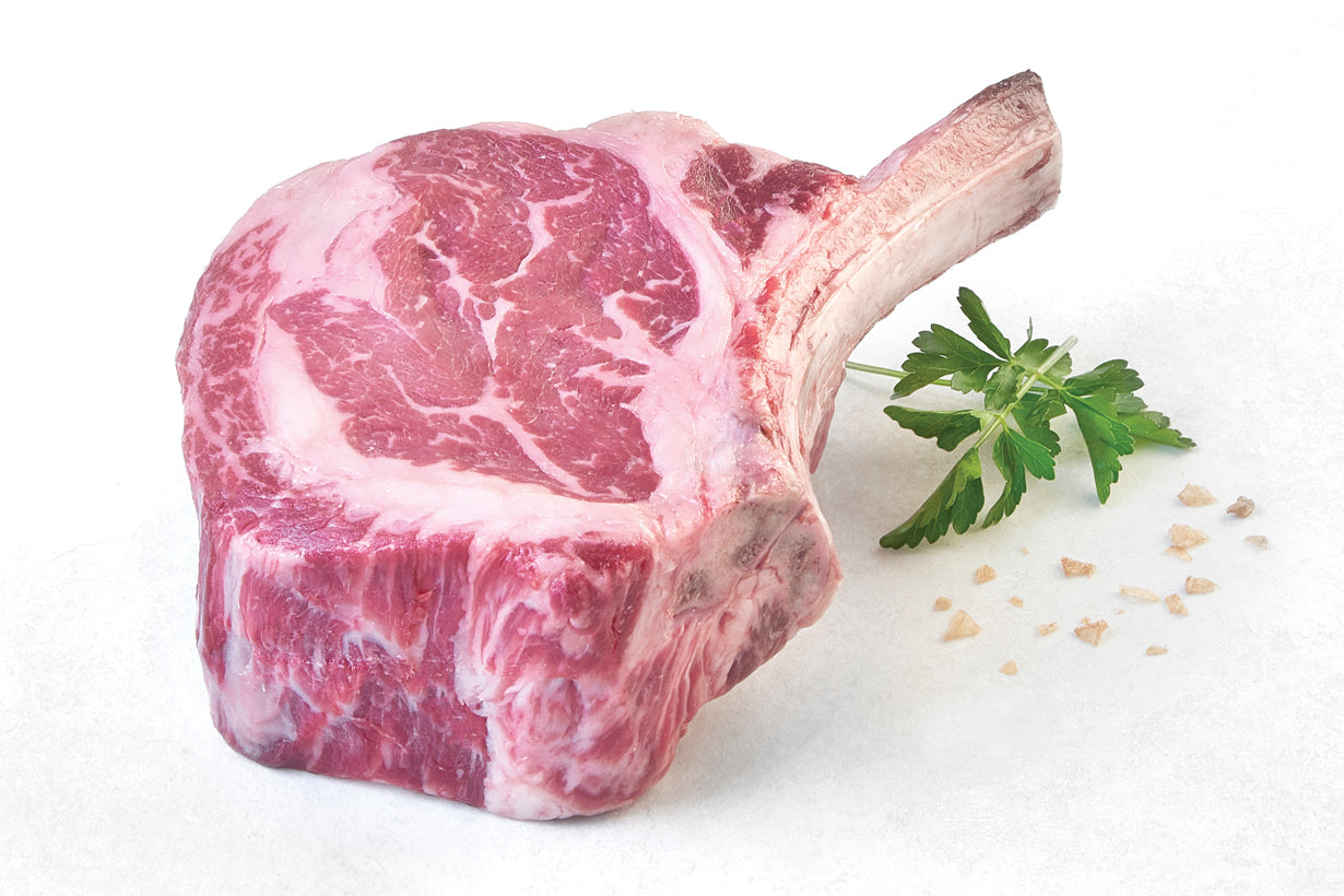 Raw dry aged USDA Prime Cowboy Ribeye steak from New York Prime Beef, bone-in cut with rich marbling, ideal for grilling or roasting