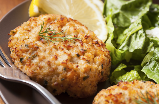 Hand Made Premium Crab Cakes from New York Prime Beef, featuring jumbo lump Maryland crab cakes, golden brown crust, and fresh herbs for an authentic gourmet presentation