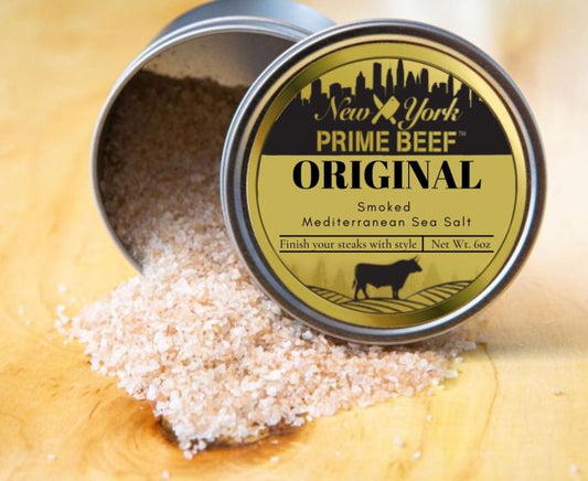Smoked Mediterranean Sea Salt from New York Prime Beef, coarse pink crystals spilling from an open tin for gourmet seasoning