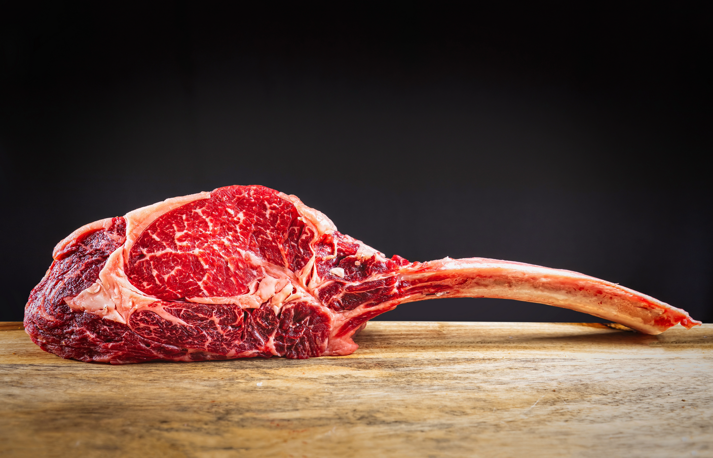 Premium Tomahawk Ribeye Steak from New York Prime Beef, dry-aged and hand-cut for exceptional flavor and marbling.