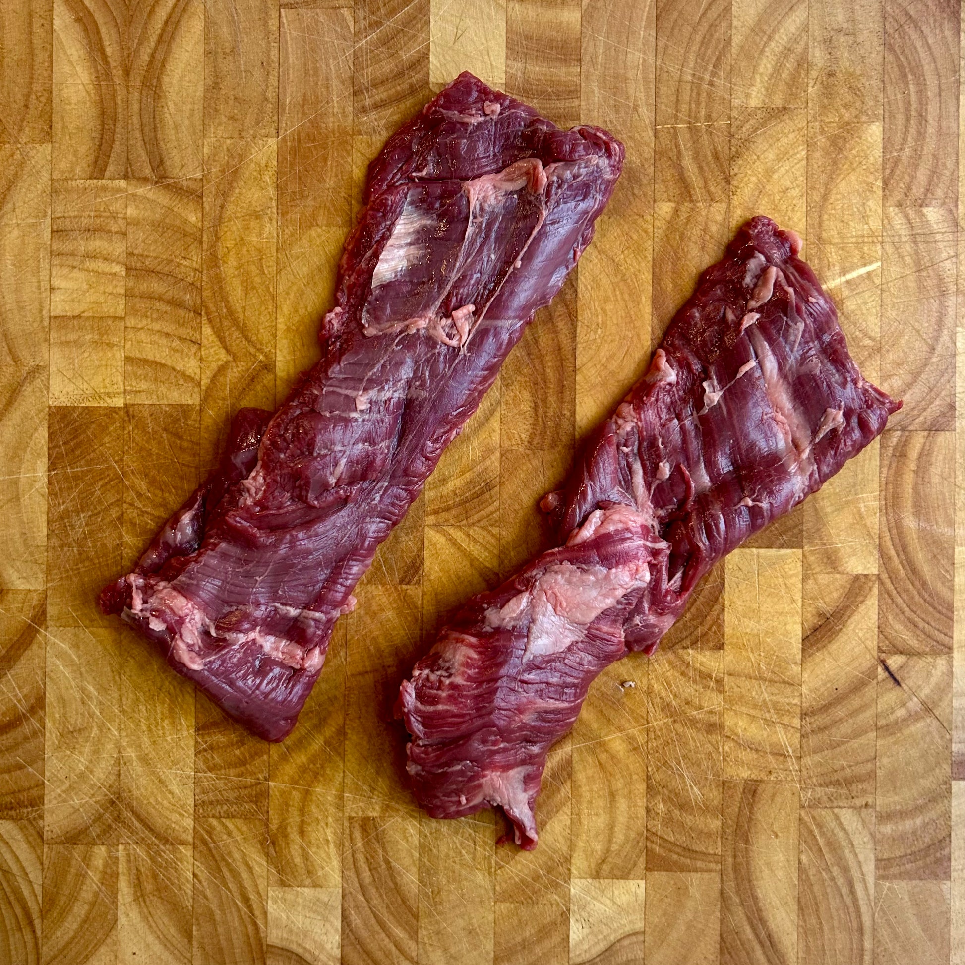 Kosher outside skirt steak raw vacuum sealed, thin cut with natural marbling, ideal for grilling or high heat searing