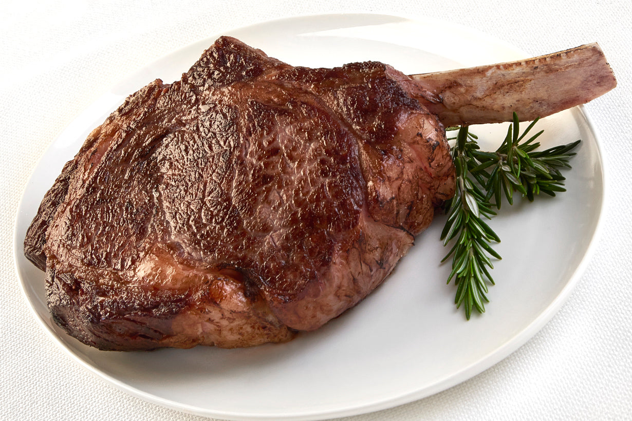 Dry aged USDA Prime Cowboy Ribeye steak from New York Prime Beef, bone-in and cooked to perfection with a rich steakhouse flavor