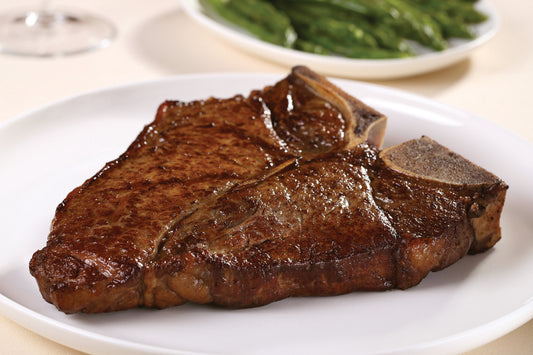 Dry aged USDA Prime T-Bone steak from New York Prime Beef, perfectly cooked with rich marbling for a classic steakhouse experience