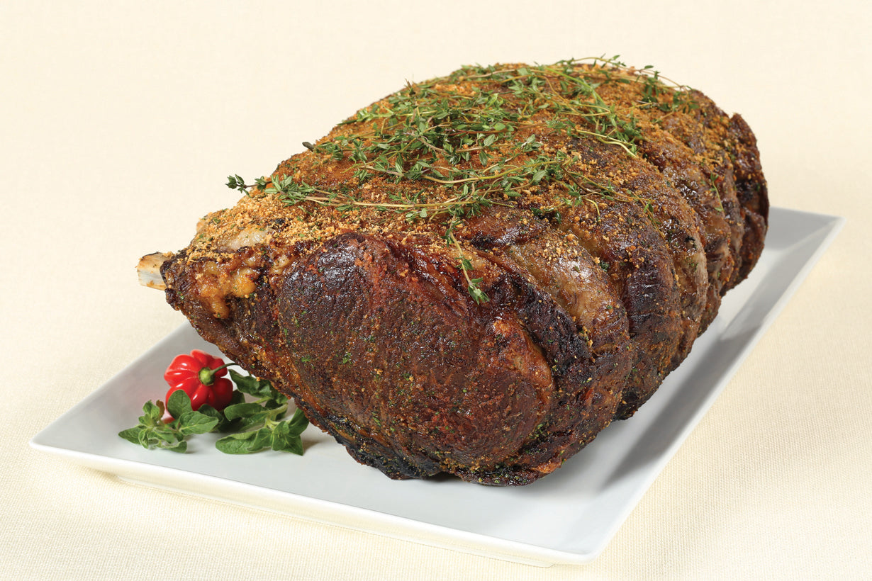 Cooked Dry-Aged USDA Prime 7-Bone Rib Roast from New York Prime Beef, tender and flavorful with rich marbling. seasoned and on plate.